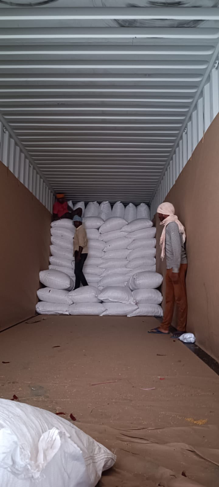 White sacks stacked in container